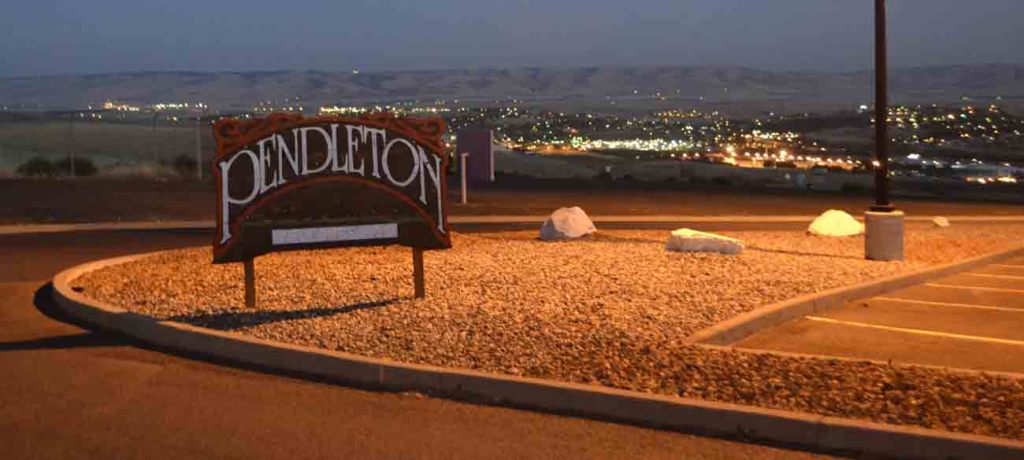 Pendleton's airport looks down on the town below.  Beyond the town is a mountain range.