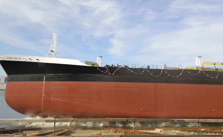 The barge descends into the Willamette River.