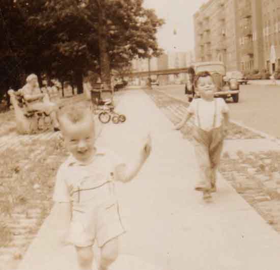 Jonathon runs merrily down the Bronx sidewalk in front of his apartment building while Mason struts proudly behind.